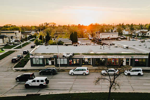 A parking lot with cars and a building with a sign that reads "FRESH & EASY".