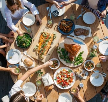a group of people sitting around a table eating food