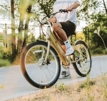 a man riding a bike down a sidewalk