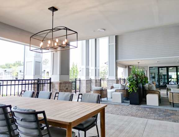 A modern dining area with a long wooden table and chairs.