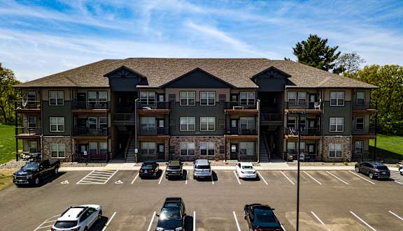 A large building with a parking lot in front of it.