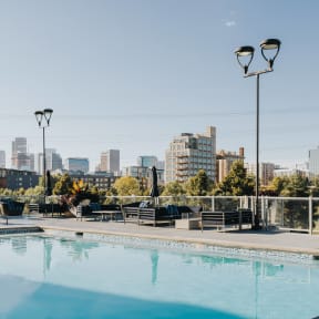a swimming pool with a city skyline in the background