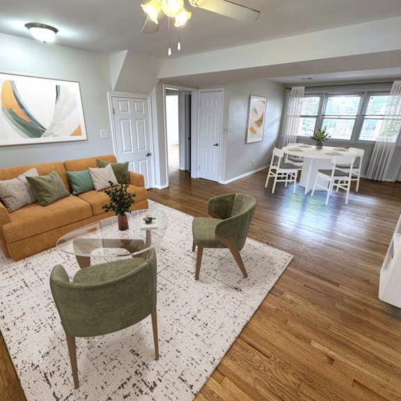 A room with wooden flooring and white walls.