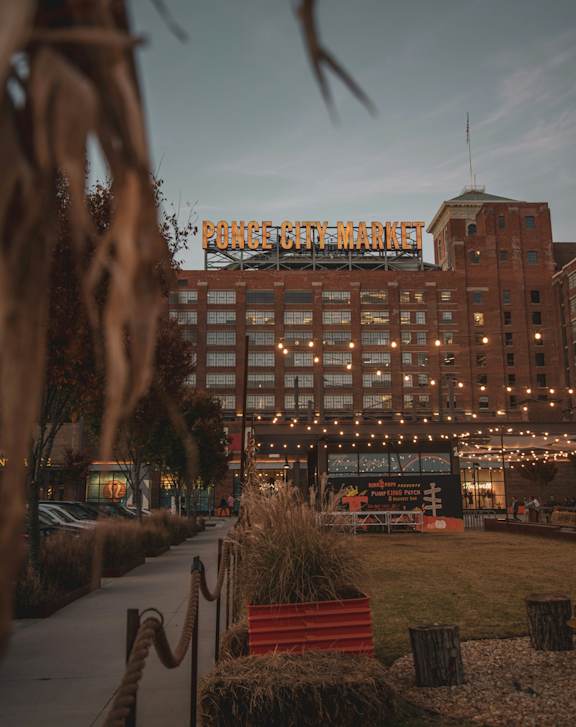 A building with a sign that reads "Police City Market" is lit up with lights.