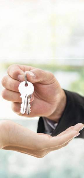 a person handing a keys to a hand with a hand holding a hand outstretched