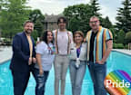 a group of people standing in front of a swimming pool