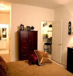 a bedroom with a bed and a dresser at The Sanctuary of Lake Villa, Lake Villa, IL