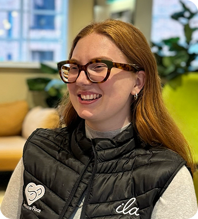 a woman wearing a black jacket sitting on a couch