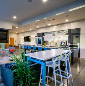 a kitchen and living room with a blue table and chairs