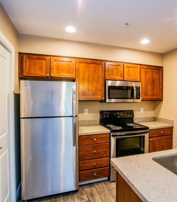 a kitchen with stainless steel appliances and wooden cabinets
