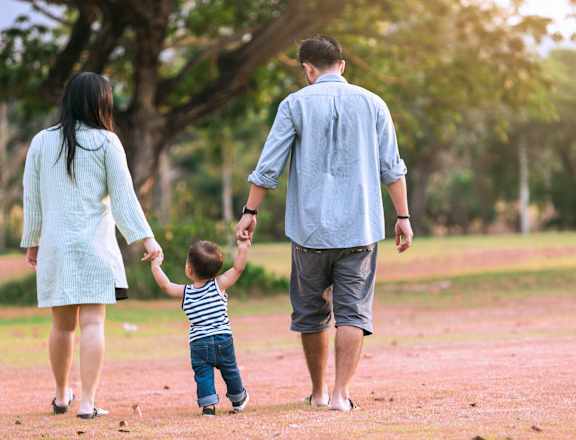 a family walking in the park with a child
