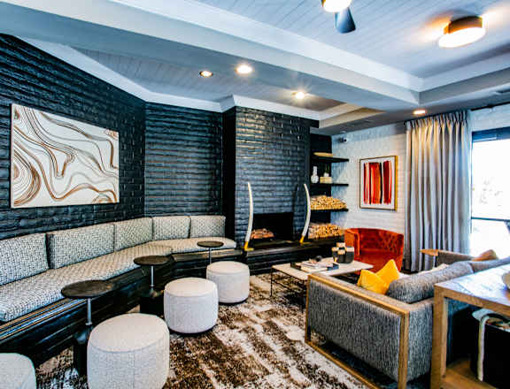 a living room with couches and chairs and a fireplace