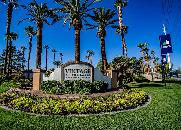 the sign at the entrance of a villa with palm trees