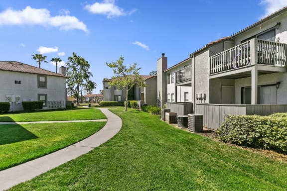 take a stroll through the grassy area at villas at houston levee west apartments
