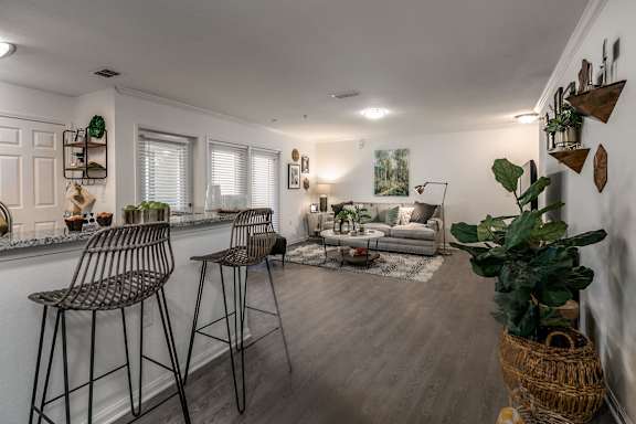 A living room with a bar area and a couch.