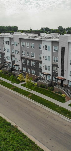an aerial view of an apartment building on a city street