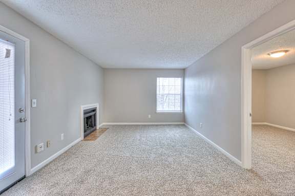 A spacious room with a fireplace and a window at Landmark at Lyncrest Reserve Apartments, Nashville, TN, 37209