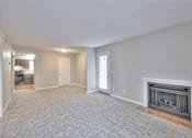 Thumbnail 16 of 28 - A spacious living room with a fireplace and a door leading to another room at Landmark at Lyncrest Reserve Apartments, Nashville, TN, 37209
