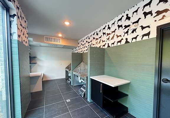 a utility room with a sink and a desk in a bathroom with a mirrored wall at The Wren Apartments, Lawrenceville, 30043