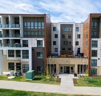 Apartment complex with a mix of brown and white buildings.at Skyway Apartments, Calgary, AB T3B 5V6