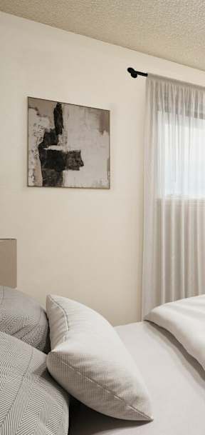 A bedroom with a large bed and a ceiling fan.