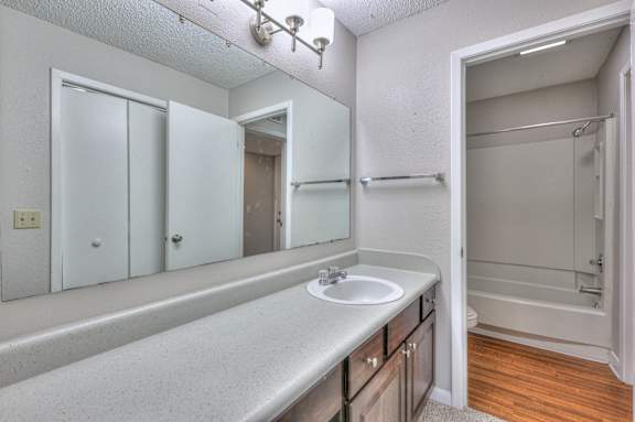 A bathroom with a sink, mirror, and shower at Landmark at Lyncrest Reserve Apartments, Nashville, TN, 37209