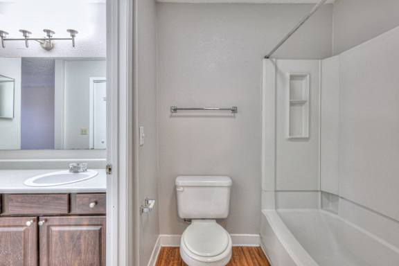 A white toilet in a small bathroom with a white tub at Landmark at Lyncrest Reserve Apartments, Nashville, TN, 37209