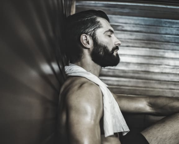 a man with a beard and a towel around his neck