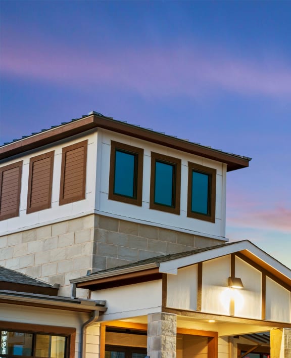 a row of houses with a sunset in the background