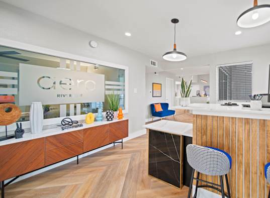 a kitchen with a counter top and a desk with chairs