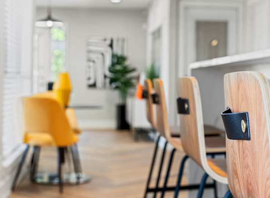 a dining room with wooden chairs and a table