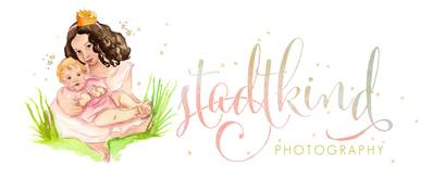 A logo for a photography business featuring a woman and a baby.