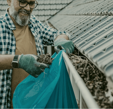 A man is holding a bag of compost in his hands.
