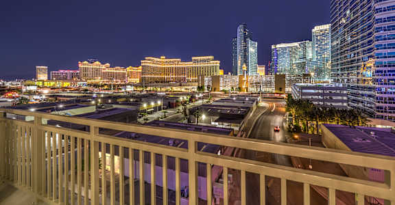 A cityscape at night with a lit-up highway.