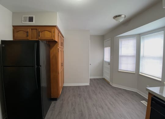 View of dining area, fridge and big windows