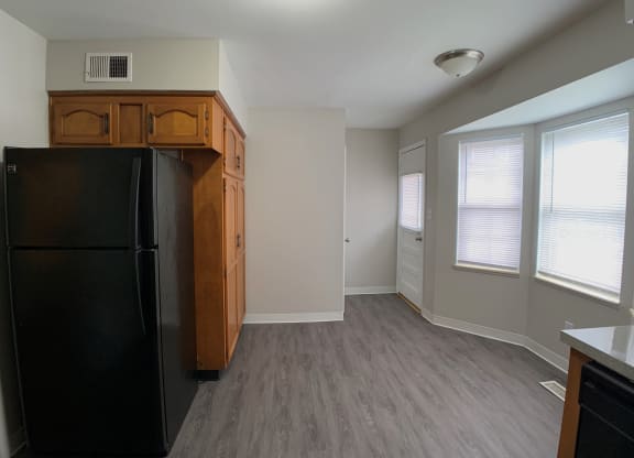 View of dining area, fridge and big windows