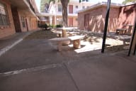 a picnic table in the courtyard of a building