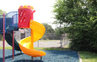 a playground with a yellow and red slide
