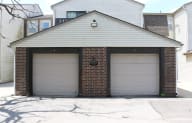 a garage with two garage doors in front of a house