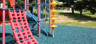 a colorful playground in a park at Canyon Creek Apartments, Kansas City, 64132