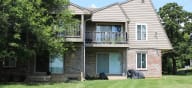 a house with a yard in front of it at Canyon Creek Apartments, Kansas City, 64132