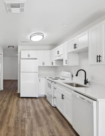 a kitchen with stainless steel appliances and white cabinets