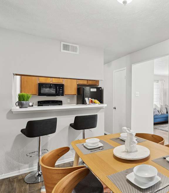 A dining room with a table set for two.