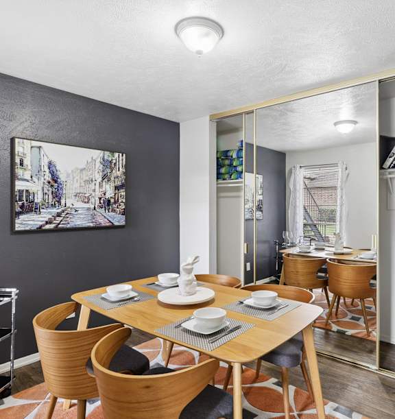 A dining room with a wooden table and chairs.