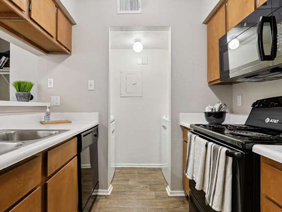 A kitchen with a stove, microwave, and oven.