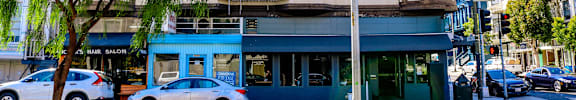 a building on the corner of a street with cars