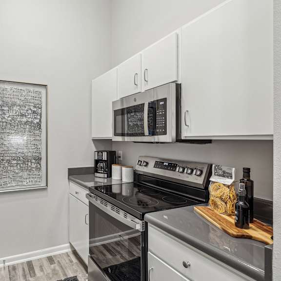 an open kitchen with a bowl of fruit on the counter