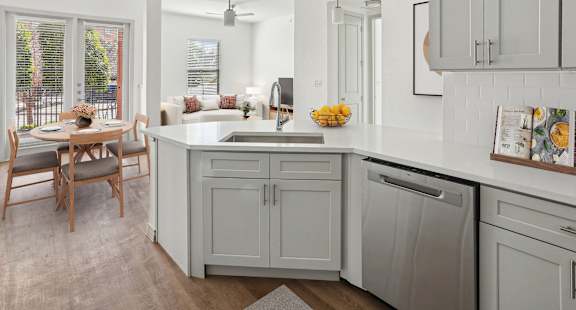 A kitchen with a table and chairs by a window.