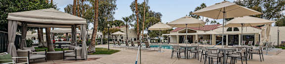 A pool area with a gazebo and lounge chairs. at La Privada, Scottsdale, AZ