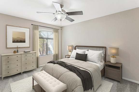 A bedroom with a large bed, a dresser, and a ceiling fan. at San Montego Apartments, Mesa, AZ, 85206